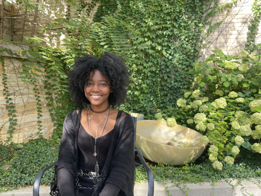 Alverno student Alisha Gilbert sits in a sunny courtyard on campus on Sept. 24, 2026. Gilbert is a junior studying music therapy.
