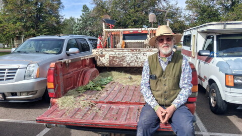 David Temple sits in an empty truck bed after handing out trees at the Cortez Public Library.