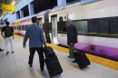 Passengers walk to board a Brightline train in Miami. Brightline first began running its trains between Miami and Orlando in 2023. The company began running its neon-yellow trains between Miami and West Palm Beach in 2018.