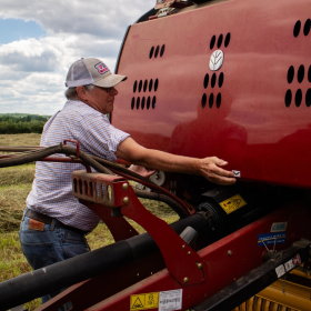 Michigan soybean farmer Bob Thompson opens up his hay baler to inspect the spool of twine on June 22, 2026. While President Trump lowered tariffs on farm machinery, it may not make much of a difference for farmers or retailers.