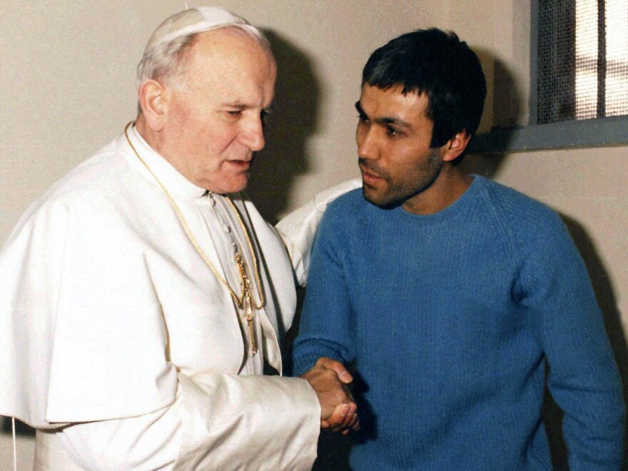 In a Dec. 1983 file photo provided by Vatican newspaper <em>L'Osservatore Romano</em>, Pope John Paul II meets Mehmet Ali Agca, in Agca's prison cell in Rome.