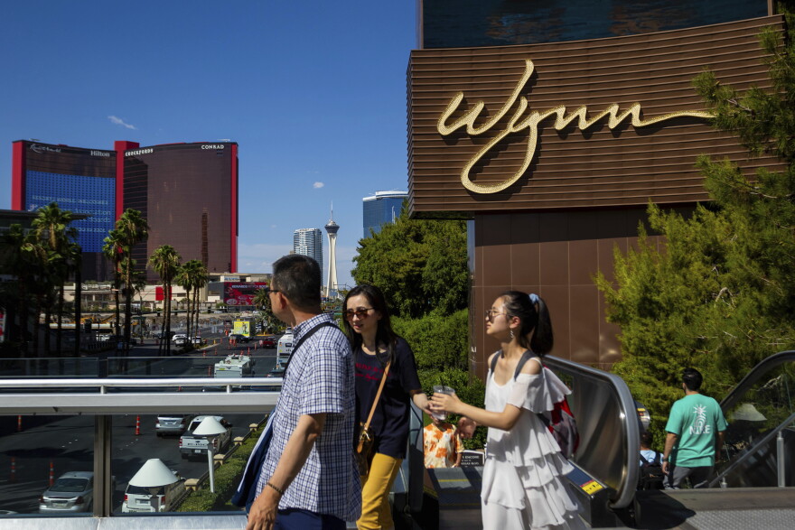People walk near the Wynn Las Vegas resort on Wednesday, July 26, 2023, in Las Vegas.