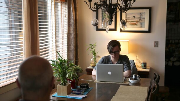 FILE - Skylar Isaacs (right) takes online classes as a high school junior.