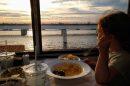 Transportation analyst Seth Kaplan's daughter enjoys macaroni and cheese with a view while riding in an Amtrak dining car. (Photo by Seth Kaplan/Here & Now)