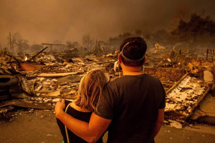 Megan Mantia, left, and her boyfriend Thomas, return to Mantia's fire-damaged home after the Eaton Fire swept through, Jan. 8, 2025 in Altadena, Calif. (Ethan Swope/AP)