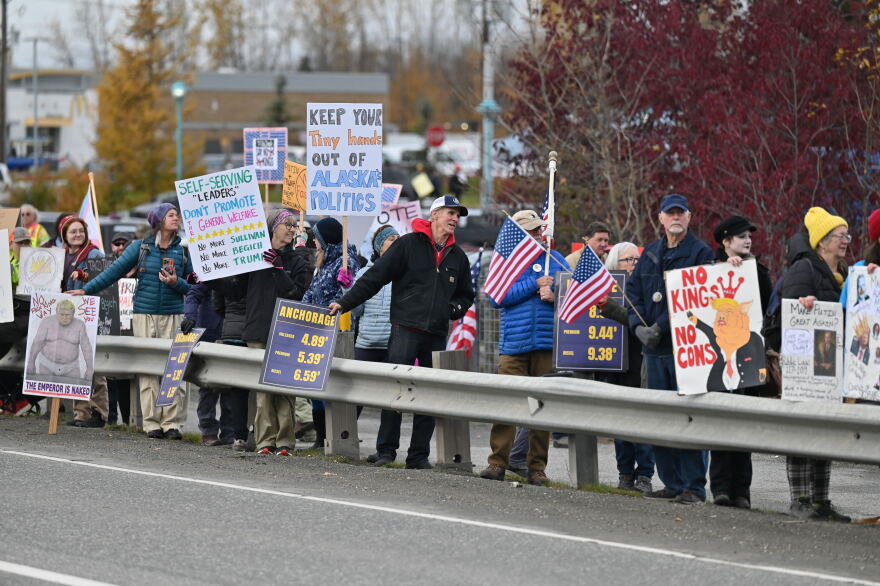 Hundreds gathered Tuesday afternoon near Wasilla Lake to protest President Trump's rally.