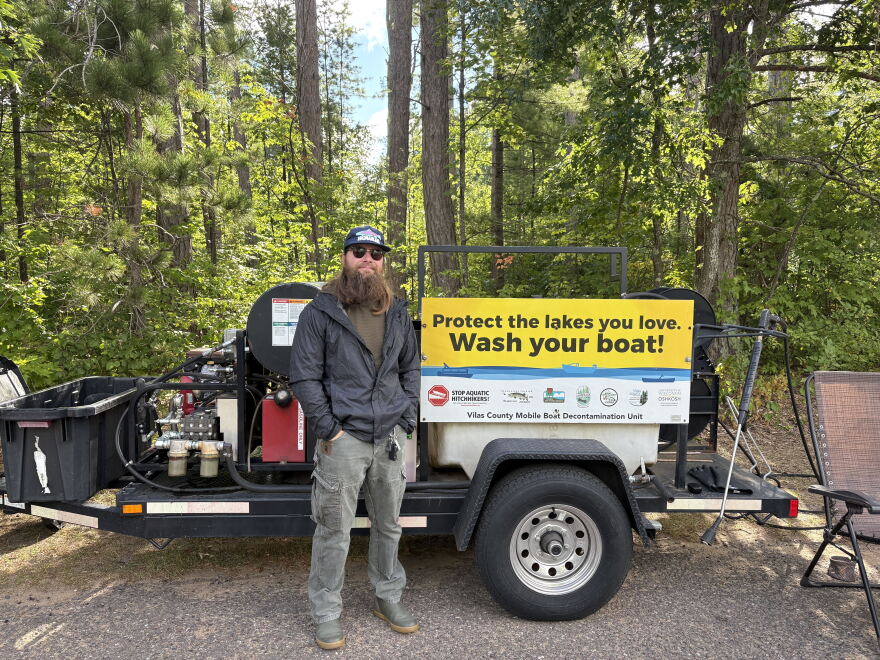 Stirn poses infront of the decon unit. It carries a water heater, tank , and different attachments.