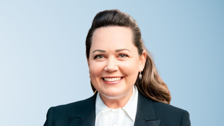 Woman with long hair in shirt and blazer