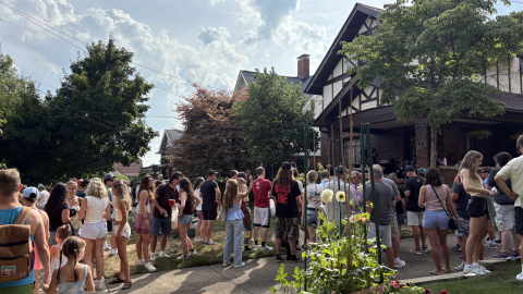 a crowd gathering in front of a porch in Highland Square