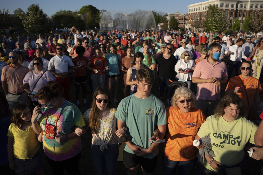 People participate in a memorial service and prayer vigil for the Lesslie family at Fountain Park, Sunday, April 11, 2021, in Rock Hill, S.C. Dr. Robert Lesslie and his wife, Barbara Lesslie, their grandchildren Adah Lesslie and Noah Lesslie, and two men working at the Lesslie home, Robert Shook and James Lewis, were fatally shot last week by former NFL player Phillip Adams. (AP Photo/Sean Rayford)