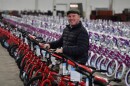 State Sen. Marty Flynn poses for a photo on one of the 1,100 bicycles that will be distributed to area children.