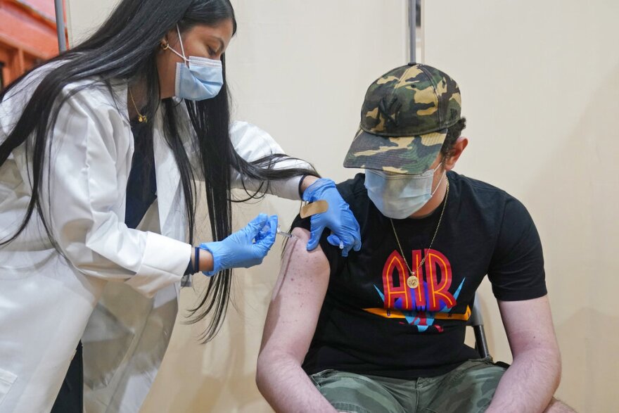 A nurse gives a teen a COVID-19 vaccine.