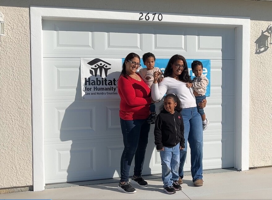 The Villaman family accepting the keys to their new Habitat for Humanity home in McNeil Village. The hiome is one of 14 that will be constructed through a unique federal grant that was made available after Hurricane Ian.