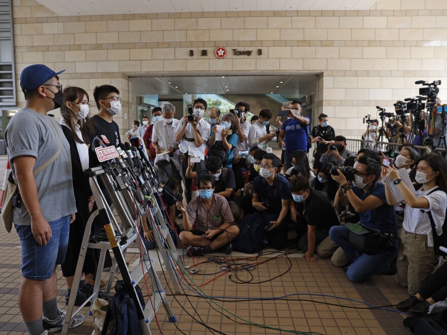 From left, pro-democracy activists Ivan Lam, Agnes Chow and Joshua Wong arrive at a Hong Kong court last week for sentencing after Chow pleaded guilty to inciting others to participate in an unlawful assembly, as well as to participating in an unauthorized assembly, related to protests in June 2019.