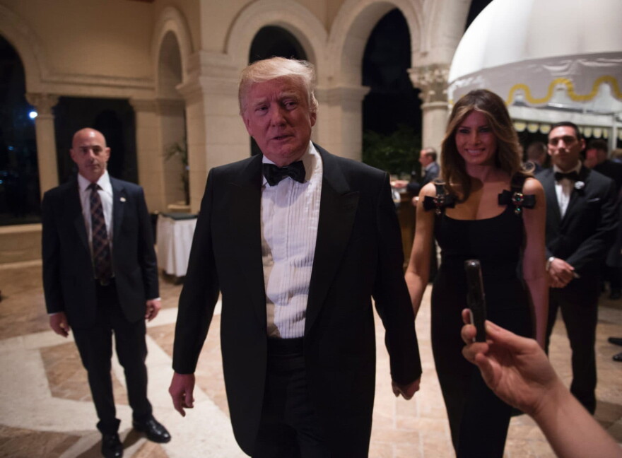 President-elect Donald Trump answers questions from reporters accompanied by his wife Melania for a New Year's Eve party Dec. 31, 2016 at Mar-a-Lago in Palm Beach, Fla. (Don Emmert/AFP/Getty Images)