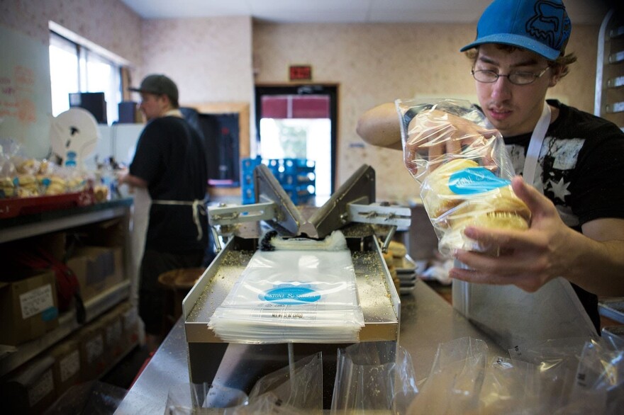 In this 2015 file photo, finished English muffins are put in bags Stone & Skillet. (Jesse Costa/WBUR)