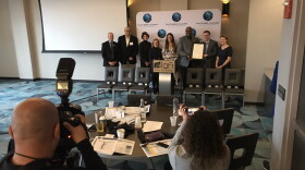 Local and state leaders in workforce and education pose with a "21st Century Talent Region" proclamation issued by Gov. Eric Holcomb.