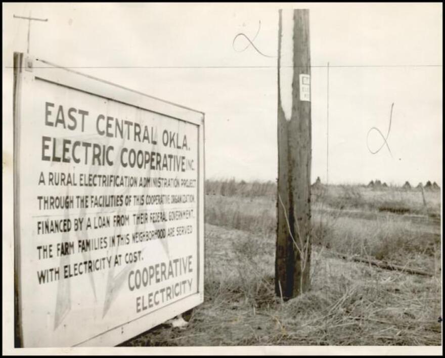 A Rural Electrification Administration sign in Beggs, Oklahoma, in 1942 that states new transmission line is financed by a loan from the federal government's storehouse of tax money. 