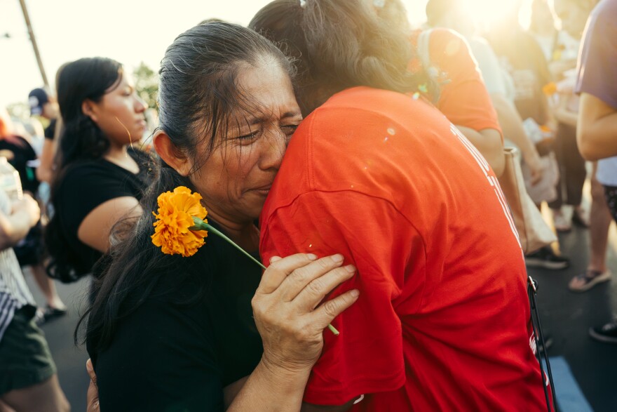 Olga Pérez Paz joins hundreds to mourn the killing of her brother Nixon Pérez Paz and his wife Glendy González de la Cruz during a vigil outside Overland City Hall on Sunday evening. The couple was found shot to death in Guatemala last month after González de la Cruz returned there to reunite with her husband following his deportation, despite having an active asylum case.
