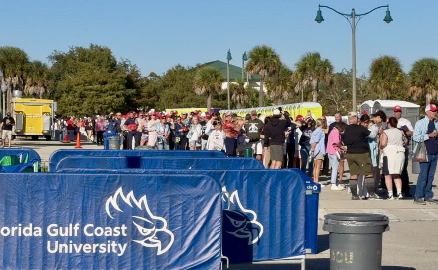 President Trump's supporters wait to enter Alico Arena for his latest campaign rally in advance of the 2026 midterm elections.