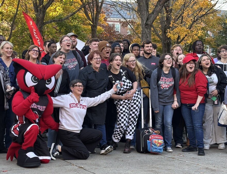 Students and their college president gather for a photograph outside. 