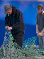 Fishermen Ed Stewart (left) and Tannis Goodsen mend groundfishing nets on Merrill Wharf, in Portland, Maine, last November.