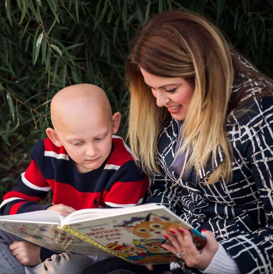 Bridgeton resident Meagan Beckerman reading to her son Trevor, who has a rare form of alopecia.