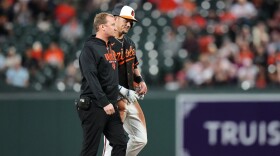 Baltimore Orioles' Ryan Mountcastle, right, leaves the field after an injury on a double during the second inning of a baseball game against the San Francisco Giants, Saturday, April 11, 2026, in Baltimore. (AP Photo/Stephanie Scarbrough)