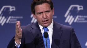 Gov. Ron DeSantis speaks at a podium at the annual leadership meeting of the Republican Jewish Coalition, Nov. 19, 2022, in Las Vegas.