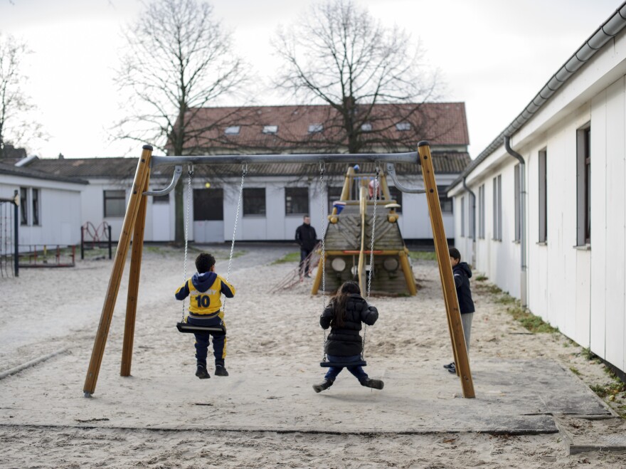 Syrian refugees play on the swings in the playground at the Friedland refugee center on Dec. 10.
