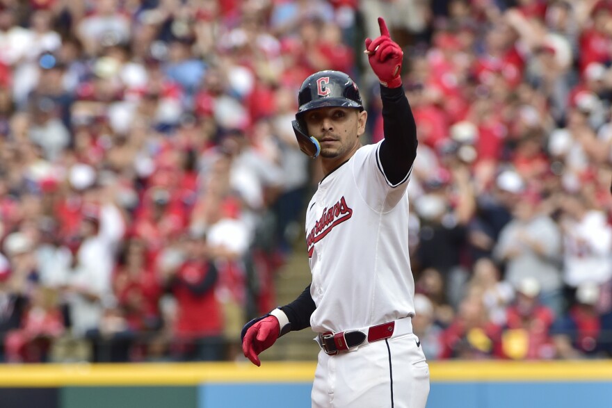 Cleveland Guardians' Andres Gimenez gestures after hitting a double in the eighth inning during Game 5 of baseball's American League Division Series against the Detroit Tigers on Oct. 12, 2024, in Cleveland.