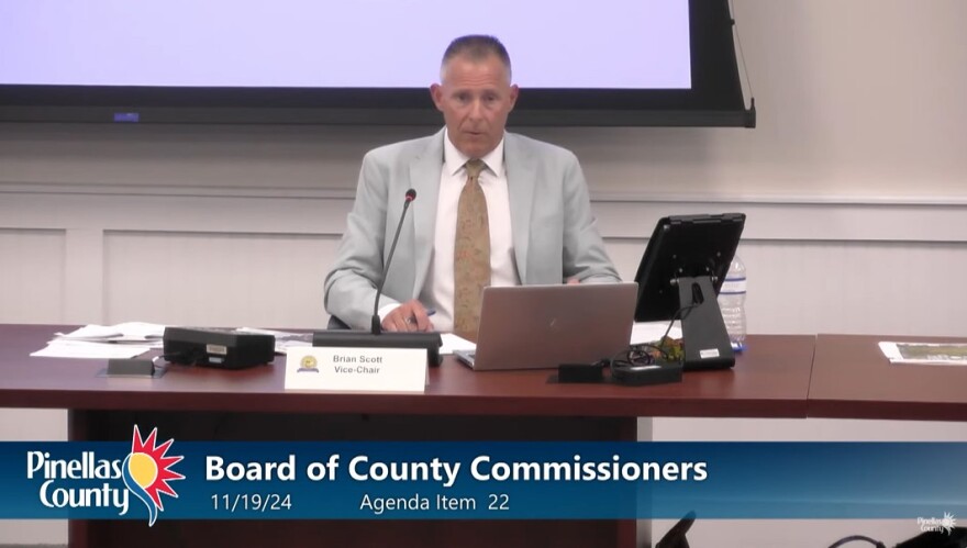 Commissioner seated at dais