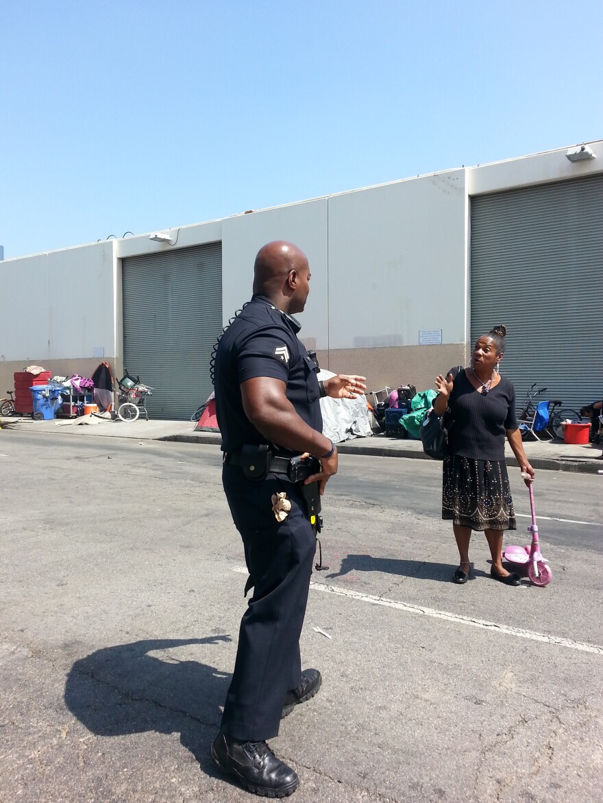 LAPD Officer Deon Joseph talks with one of the women who call Skid Row home.