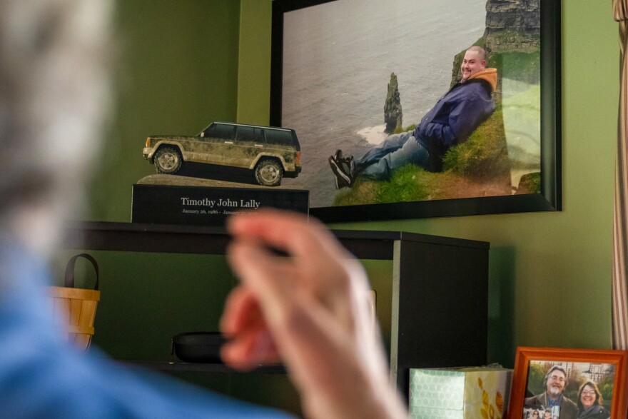 John Lally shows a portrait and the custom urn of his son Tim who died in 2016. John now sits on the state’s opioid advisory settlement committee as a person with lived experience.