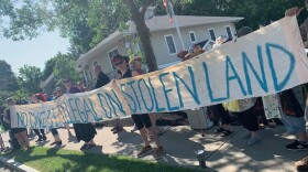 People protest in front of the U.S. Border Protection offices in Irondequoit.