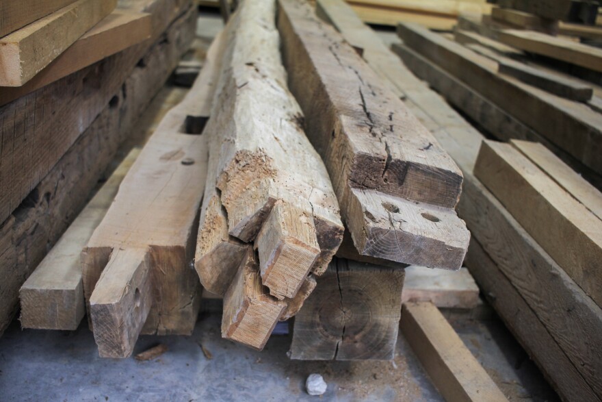 A close up of a pile of roughly hewn wood.