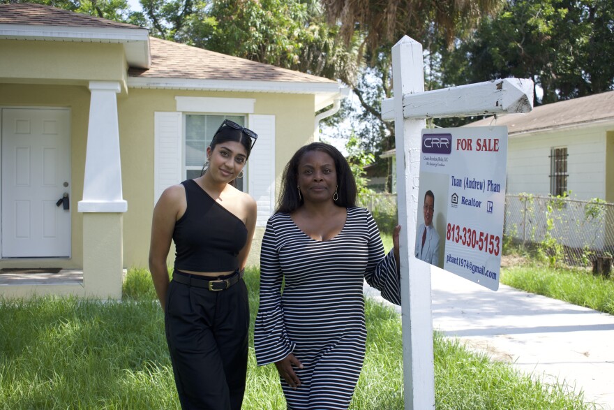 On Chelsea Street in East Tampa, Antoinette Hayes-Triplett and realtor Melisha Patel stand outside of a home that's expected to close with the Tampa Hillsborough Housing Initiative by the end of the month.