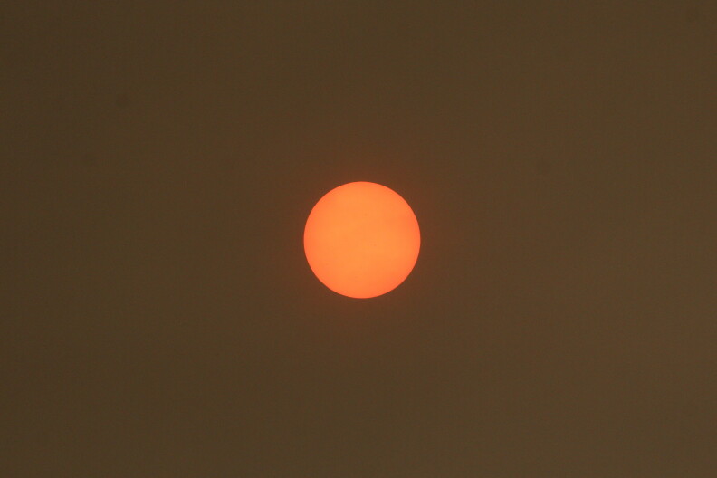 The sun sits in the sky.