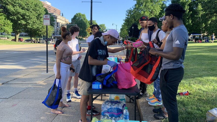 Members of the Black People's Party of America in Springfield - a group of young organizers who planned Black Lives Matter protests - collect food and other donations to hand out to people who are homeless. 