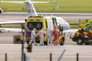 Medics escort a patients, evacuated from the MV Hondius cruise ship with suspected hantavirus infection, to an ambulance after being flown to Schiphol airport, Amsterdam, Netherlands, Wednesday, May 6, 2026.