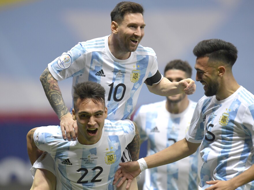 Lautaro Martinez (left) of Argentina celebrates with teammates Lionel Messi (center) and Nicolás Gonzalez after scoring his team's first goal during its semifinal match against Colombia at Mane Garrincha Stadium on July 6 in Brasilia, Brazil, during the Copa America Brazil 2021.