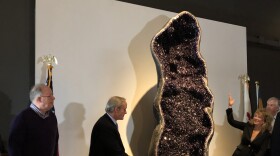 During a 10th anniversary celebration Thursday, Peoria Riverfront Museum representatives unveil a 10-foot amethyst geode added to the museum's permanent collection.