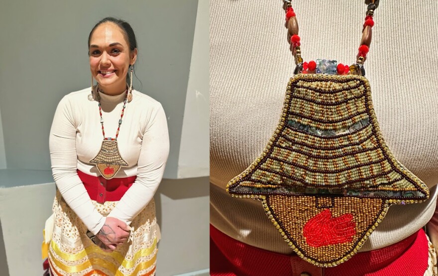 Smiling woman with beadwork.