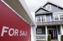 A "For Sale" sign stands in front of a home that is in the process of being sold.