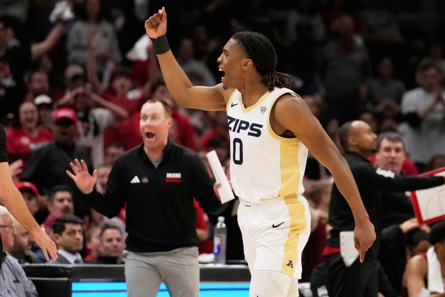 Akron forward Amani Lyles (0) reacts to an official's call in front of Miami (Ohio) head coach Travis Steele, left, in the second half of an NCAA college basketball game in the championship of the Mid-American Conference tournament, Saturday, March 15, 2025, in Cleveland, Ohio. 