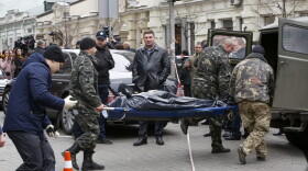 Forensic experts carry the body of Denis Voronenkov, after he was shot dead in Kiev, Ukraine, Thursday, March 23, 2017. (Sergei Chuzavkov/AP)