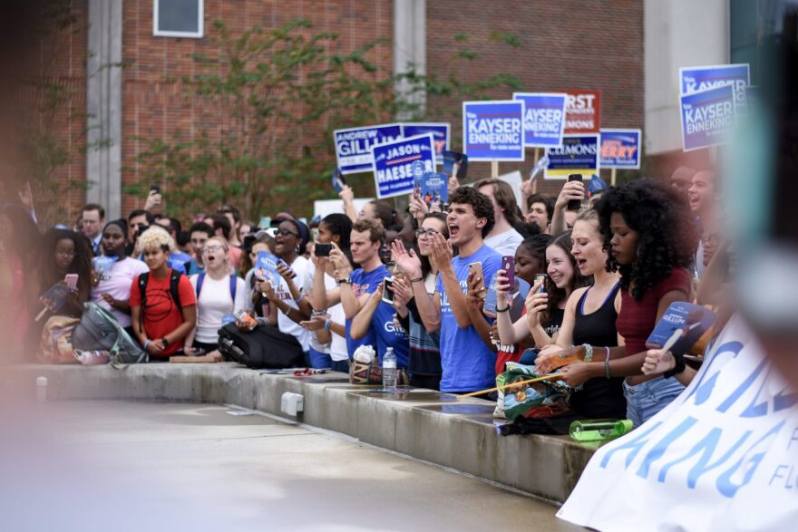 Members of a crowd cheer as Tallahassee Mayor Andrew Gillum, the Democratic nominee for governor, hosts a rally at the Reitz Union North Lawn on the University of Florida's campus Oct. 26, 2018. (Dakota Williams/WUFT News)