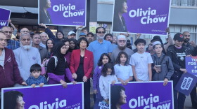 Mayor Olivia Chow poses with condo residents and campaign signs during election season