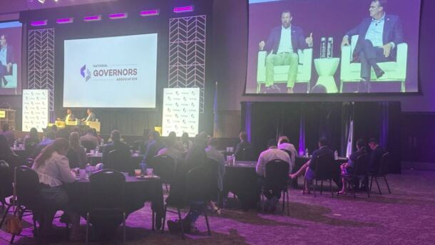 U.S. Homeland Security Secretary Markwayne Mullin speaks with Oklahoma Republican Gov. Kevin Stitt Saturday at the National Governors Association summer meeting in Oklahoma City. Mullin, a former U.S. senator from Oklahoma, urged states to cooperate with federal immigration arrests.