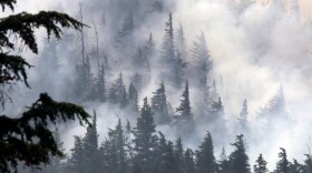 As in Washington, fire conditions in Oregon are high. In this photo the Dollar Lake fire smolders Tuesday near Laurance Lake, on Mount Hood, Ore. Firefighters labored to build containment lines before windy conditions return early this morning.